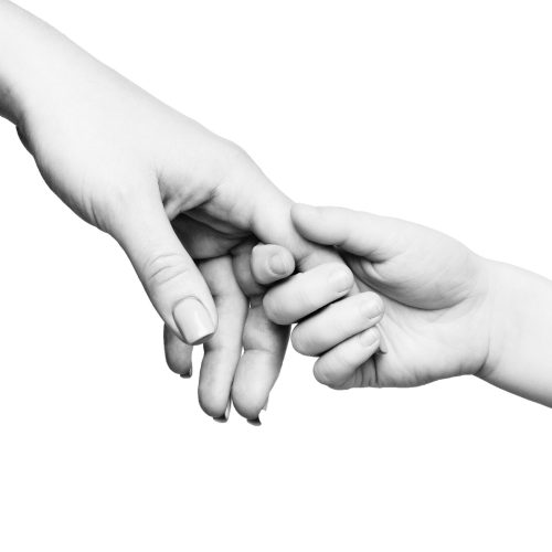 Love in every touch. Child hand holding mother finger on white background, panorama, copy space